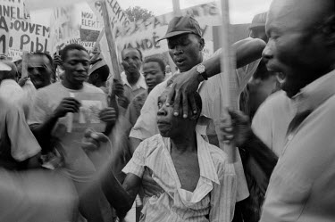 A man is assaulted by supporters of the right wing FRAPH (Front pour l'Avancement et le Progres Haitian) militia.
