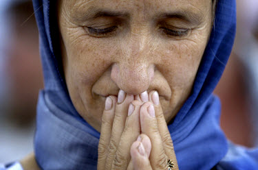 A woman mourns as Srebrenica survivors march along the 'Road of Death', the route they used when trying to escape the enclave ten years earlier. An estimated 8,000 Bosniak (Muslim) men and boys from t...