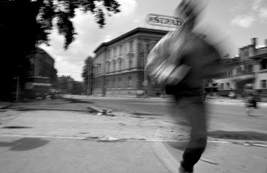 People run along a city street to avoid sniper fire during the siege on Sarajevo by Serb troops. Around 250,000 people lost their lives in the conflict between Bosnian Muslims, Croats and Serbs that r...