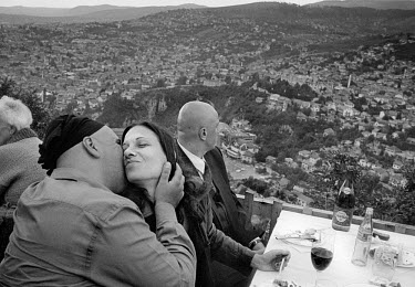 A couple kiss as they celebrate their wedding high above the city in the Biban restaurant, which is close to the former front line during the civil war. Around 250,000 people lost their lives in the c...
