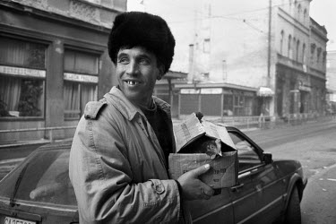 A man carries a chicken in a box during the siege on Sarajevo by Serb troops. As food becomes in short supply citizens have had to learn to be self-sufficient, by rearing livestock and growing their o...
