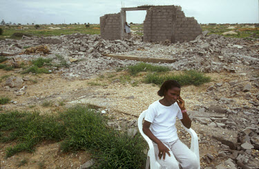 A woman in the ruins of her home in the middle class area known as Golfe 2. In December 2002, men, presumably from the government, forcibly demolished privately owned homes on this land. The land titl...
