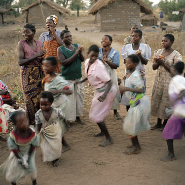 Women and children villagers enjoy themselves by singing and dancing in the late afternoon, despite the difficult economic conditions they face with the poor harvest.    The village of Dickson contain...