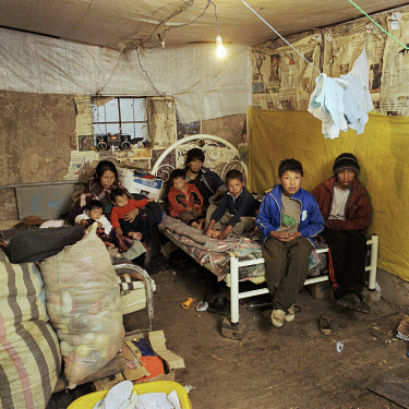 Contract worker Secunbdino Rojas Quispe (39) with his wife Theophilia Sanchez Inciso (39), and 6 of their 8 children sit in their house.  Many children who live locally have traces of lead in their bl...