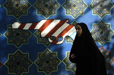 A woman passes a mural on the wall of the former US Embassy in Tehran. The embassy was seized by student militants in 1979.