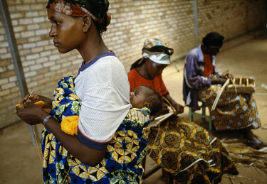Dorothy Mbazumutima (27) with other members of the AIDS Association at Kansi Health Centre take part in basket and handicraft-making.  All the women are HIV positive and for one or two days a week com...