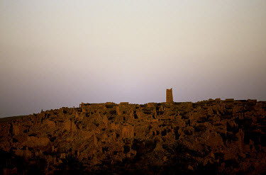 The ancient mosque of the city remains on the horizon.  The settlement is almost entirely abandoned due to desertification.