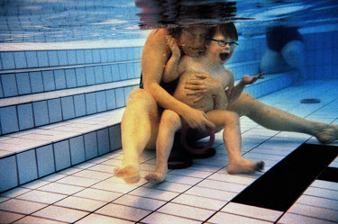 Jesper Nylund sits underwater with his mother in the swimming pool.  He enjoys swimming.  Six year old Jesper has Down Syndrome and although he is unable to talk, communicates through sign language.