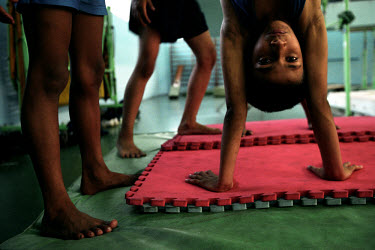 A boy performs a handstand during his gymnastics practice at the National Sports Training Institute.