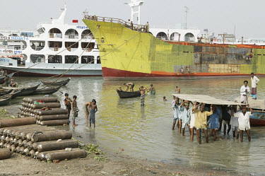 Labourers on a ship construction site complete the hull of a passenger ferry.  Materials used in the shipyards of Bangladesh are often taken from decommissioned and dismantled ships.