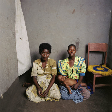 Rosemary Makanga (33) sits in her house with Dorothy Blackisoni (24) and her daughter Masiye (1).  Rosemary is seven months pregnant by a man whom she met as a daily labourer on a farm and who promise...