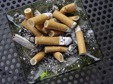 Ashtray with cigarette butts.