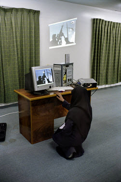 A woman using a computer to project a Hamas propaganda film in the Al Kenz mosque in the Al Rimal district.
