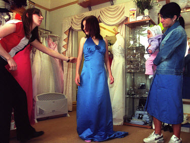 Lee Anne Huntingdon (17), chooses her prom dress in a shop with her daughter and mother.  The prom is an important event in the school calendar for school leavers, who enjoy one of their last nights t...
