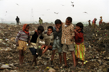 A group of children share a joke as they scavenge among refuse on the Kajla rubbish dump.  It is one of three landfill sites in this city of twelve million people.   Around 5,000 tonnes of garbage are...