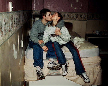 Jemma (19) and Tony kiss as they sit on the bed at home.  Tony was recently arrested after having gone AWOL from the army.  'All Dressed up' is a series exploring how various groups of teenagers socia...