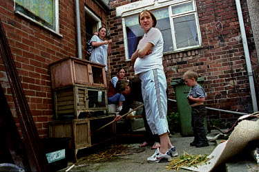 Pregnant Karlie (16) and her sisters clean out the rabbit hutch at home.  'All Dressed up' is a series exploring how various groups of teenage girls socialise and the places which are special to them....