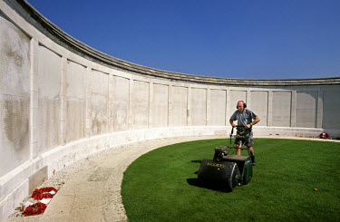 Mowing the grass at Tyne Cot National Cemetery, a graveyard for soldiers of the Commonwealth forces in World War One (WWI), which receives 150,000 visitors each year.