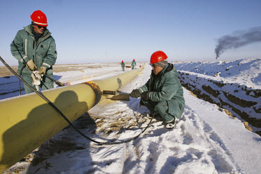 Workers lay an oil pipeline for Hurricane Kumkol Munai (formerly the state-owned oil company, Yuzhneftegazin, until it was taken over by Hurricane Hydrocarbons).