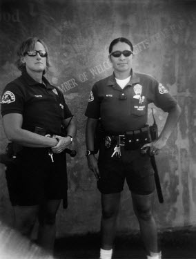 Female police officers Reyes and Curtin patrol Venice Beach.   They are on a yearly salary of $45,000.