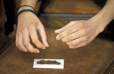Rolling a joint (marijuana) with cannabis resin.