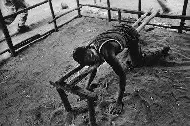 19 year old Mobo, a former child soldier sleeps on a bench having spent the day smoking marijuana.