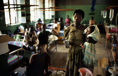 A woman stands with her child in a ward with patients being treated during an outbreak of cholera which it is believed to be present in the Yei River and an isolated water supply.  The influx of Inter...