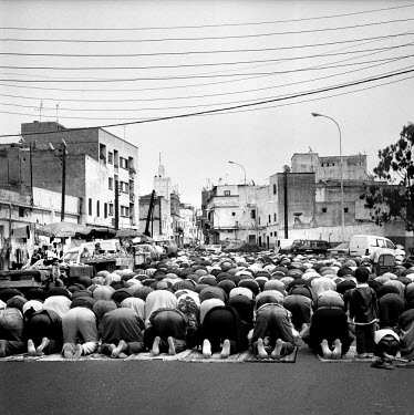 Muslims pray in the street on a Friday.