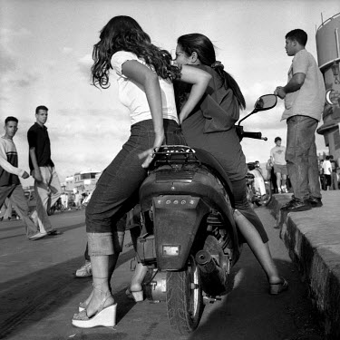 Girls sitting on a motorbike in Djemma el Fna, the city's central square.