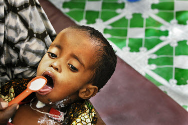 A malnourished child is spoonfed milk at the Wajir District Hospital, during a severe drought which extended across East Africa after the rainy season expected in October 2005 failed to arrive. Diarrh...