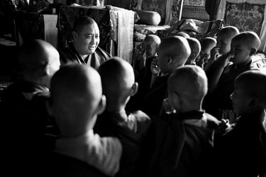Shechen Ramjam Rinpoche surrounded by young Tibetan Buddhist monks in Shechen monastery. About 300 monks live in the monastery, from a total of around 20,000 Tibetans living in exile in Nepal.