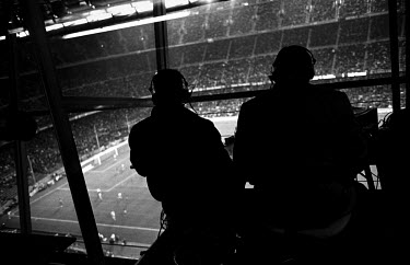 Journalists in the press box at Camp Nou watch a football match between FC Barcelona and Athletico Madrid. The stadium holds 98,000 spectators.