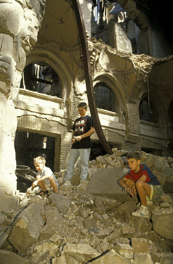 Children clearing rubble outside the war-damaged former National Library.