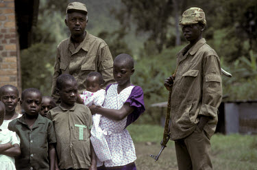 Troops from the Tutsi-led FPR (Front Patriottique Rwandais), the Rwanda Patriotic Front, with war orphans.