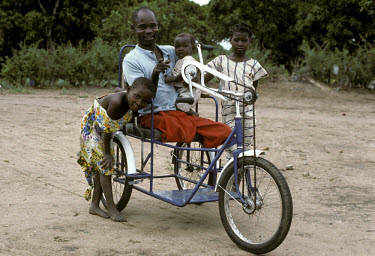 A former soldier in a hand-powered tricycle at an army amputee camp.