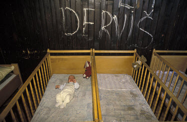 A baby in a cot in the Bjelave orphanage.