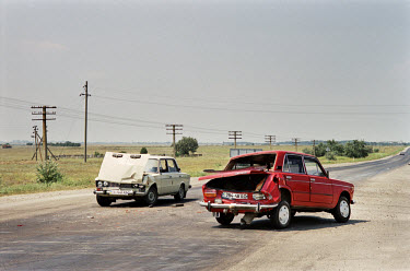 A damaged Lada and a Zastava car in the middle of the road after a traffic accident.