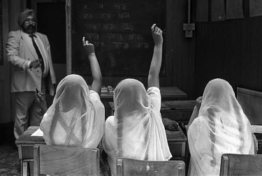 Sikh girls learning Gurmukhi, the script used by Sikhs to write in Punjabi, at the supplementary school attached to the Guru Gobind Singh temple.