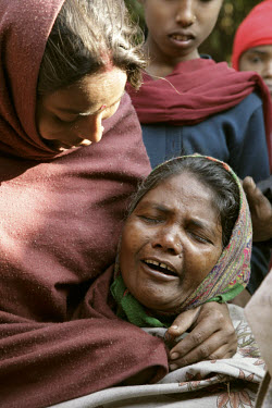 A woman mourns her son who was beaten to death in a police raid on their adivasi tribal village. The raid, where police targeted innocent members of the adivasi community followed the robbery of a jew...