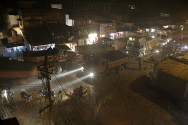 Trucks carrying iron ore drive through the town throughout the night, taking freight from mines to Indian steel mills and ports for export.