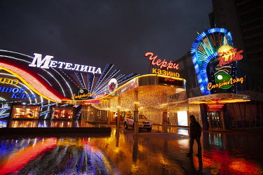 A casino on New Arbat Street is illuminated by neon lights at night.
