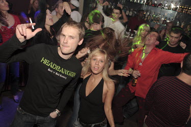 Rich young clubbers dance at a fashionable nightclub. The Russian nouveau-riche (nicknamed the ^New Russians^) have become renowned for flaunting their wealth.