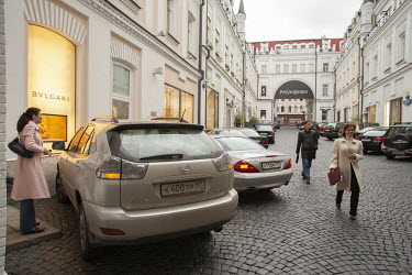 Affluent shoppers park their expensive cars outside a row of designer shops in central Moscow. The Russian nouveau-riche (nicknamed the ^New Russians^) have in recent years acquired a reputation for f...