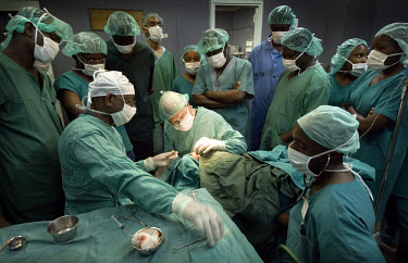 Medical students watch Dr. Asrat Mengiste, an Ethiopian doctor working for the African Medical and Research Foundation (AMREF), perform an operation at KCMC hospital. AMREF, an international health de...