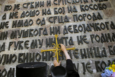 A Serbian priest makes a crucifix out of candles with four Cs ('Samo Sloga Serbina Spasava' - 'Only unity saves the Serbs') at the monument to the Battle of Kosovo Field (1389) at Gazemestan. Every ye...
