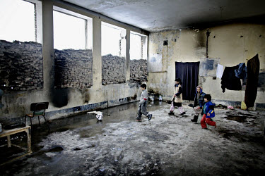 Children playing football in a ruin on the outskirts of Kabul. The family have returned to their homeland after many years as refugees. Their father, forty-five-year-old Dawlat Khan, reveals, ^I lost...