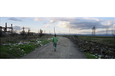 A young boy walks home near the town of Obilic.