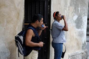 Coffee Cuban style - private enterprise. People drinking small cups of strong coffee being sold for 1 Cuban peso in a doorway in Old Havana.