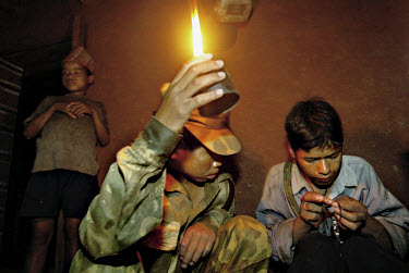 Sunil and Sushil, two young Maoist soldiers, are trying to fix a cassette tape of Maoist propaganda by the light of a paraffin oil lamp.