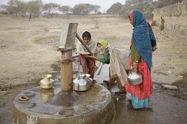Early morning at a hand pump, Azmer district. Rajasthan has been suffering a drought for the last eight years and underground water levels are severely depleted. Water at hand pumps such as this one i...